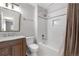 Updated bathroom with subway tile surround, bathtub, and wood vanity at 229 Berthoud Way, Golden, CO 80401