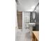 Cozy bathroom featuring tiled floors, a pedestal sink, and a shower with a white shower curtain at 229 Berthoud Way, Golden, CO 80401