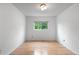 Sunlit bedroom with hardwood floors, neutral walls and ceilings, and large window views at 229 Berthoud Way, Golden, CO 80401