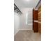 Walk-in closet with carpet, custom wood shelving, and natural light from window with shade at 229 Berthoud Way, Golden, CO 80401