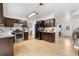 Bright kitchen with wood floors, stainless steel appliances, and dark brown cabinets at 229 Berthoud Way, Golden, CO 80401