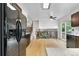 Open concept kitchen and living room with wood floors and access to the backyard at 229 Berthoud Way, Golden, CO 80401