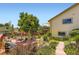 Charming backyard oasis with lush gardens, a deck, a patio, and mature trees at 702 Windmill Pl, Highlands Ranch, CO 80126