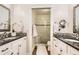 Bathroom showcasing double vanities, granite countertops, and tiled shower at 702 Windmill Pl, Highlands Ranch, CO 80126