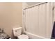Bathroom featuring tiled walls, new toilet, and shower and bath combo at 702 Windmill Pl, Highlands Ranch, CO 80126