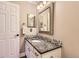 Bathroom features tiled walls, granite countertops, and large mirror at 702 Windmill Pl, Highlands Ranch, CO 80126