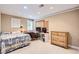Cozy bedroom with light walls features a built-in desk area and a comfortable bed and dresser at 702 Windmill Pl, Highlands Ranch, CO 80126