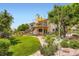 Spacious backyard with a two-story home featuring a deck, lush lawn, and garden at 702 Windmill Pl, Highlands Ranch, CO 80126