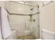 Walk-in shower with stylish tile, built-in shelves, and glass door at 702 Windmill Pl, Highlands Ranch, CO 80126