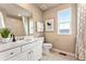 Neutral bathroom features a white vanity, toilet, shower-tub, and tiled flooring at 3352 N Buchanan Way, Aurora, CO 80019