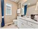 Neutral toned bathroom with white cabinets, modern fixtures, and a shower-tub combo at 3352 N Buchanan Way, Aurora, CO 80019