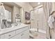 Modern bathroom featuring white vanity, quartz countertop, and tiled walk-in shower at 3352 N Buchanan Way, Aurora, CO 80019