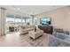 Cozy living room featuring hardwood floors, entertainment center and sliding glass doors to the backyard at 3352 N Buchanan Way, Aurora, CO 80019