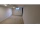 View of the carpeted basement featuring an egress window and neutral walls at 8915 Field St # 113, Westminster, CO 80021