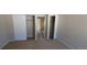 Carpeted bedroom with closet, a door to the hall and neutral wall color at 8915 Field St # 113, Westminster, CO 80021