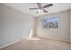 Bedroom featuring a ceiling fan, window with natural light, and neutral carpet at 8915 Field St # 113, Westminster, CO 80021