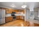 A well-lit kitchen with stainless steel appliances, ample cabinets, and hardwood floors at 8915 Field St # 113, Westminster, CO 80021