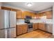 Updated kitchen boasts stainless steel appliances, wood cabinets, and sleek countertops at 8915 Field St # 113, Westminster, CO 80021