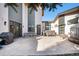 Modern backyard with concrete patio, hot tub, dining set, and sleek architectural design at 5086 N Raleigh St, Denver, CO 80212