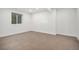 Empty basement room with concrete floors and single window, ready to customize at 5086 N Raleigh St, Denver, CO 80212