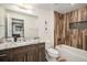 Bathroom featuring wood-look tile, modern vanity with granite top, and shower-tub combination at 5086 N Raleigh St, Denver, CO 80212