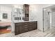 Elegant bathroom featuring double vanities with granite countertops, dark wood cabinets, and modern fixtures at 5086 N Raleigh St, Denver, CO 80212