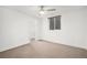 Bright bedroom with neutral carpet, ceiling fan, and a window offering natural light at 5086 N Raleigh St, Denver, CO 80212