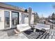 Modern rooftop deck with stylish outdoor seating, black and white rug, and city views at 5086 N Raleigh St, Denver, CO 80212