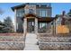 Contemporary two-story home featuring a stone facade, a front porch and a roof-top terrace at 5086 N Raleigh St, Denver, CO 80212