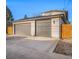 This two car garage features two gray doors and exterior lighting at 5086 N Raleigh St, Denver, CO 80212