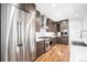 Modern kitchen with stainless steel appliances, dark wood cabinets, and sleek design at 5086 N Raleigh St, Denver, CO 80212