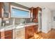 Kitchenette features cherry wood cabinets, stainless steel appliances, and views from large window at 5086 N Raleigh St, Denver, CO 80212