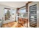 Well-lit kitchenette boasts dark cabinets, stainless steel appliances, and a doorway to a deck space at 5086 N Raleigh St, Denver, CO 80212