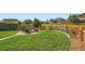Beautiful backyard features a fire pit, mature trees, green grass, and wood fence at 859 Equinox Dr, Erie, CO 80516