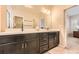 Bathroom featuring double vanity with dark wood cabinetry at 859 Equinox Dr, Erie, CO 80516