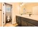 Bright bathroom featuring a double vanity with modern fixtures and a separate toilet room at 859 Equinox Dr, Erie, CO 80516