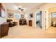 Spacious bedroom featuring a ceiling fan, carpeted floors, and a desk with an office chair at 859 Equinox Dr, Erie, CO 80516