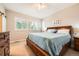 Cozy bedroom with shuttered windows, ceiling fan and carpet flooring at 859 Equinox Dr, Erie, CO 80516