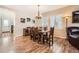 Elegant dining room featuring wood floors, plantation shutters, and a stylish chandelier at 859 Equinox Dr, Erie, CO 80516