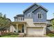 Charming home boasts a brick and siding exterior, two-car garage, and a cozy front porch at 859 Equinox Dr, Erie, CO 80516
