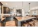 Gourmet kitchen featuring a large island, granite countertops, and stainless steel appliances at 859 Equinox Dr, Erie, CO 80516