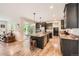 Spacious kitchen with stainless steel appliances, center island, and an open layout to the living area at 859 Equinox Dr, Erie, CO 80516
