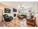 Cozy living room featuring a fireplace, hardwood floors, and ample natural light at 859 Equinox Dr, Erie, CO 80516