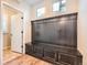 Mudroom featuring dark wood storage bench with hooks and cabinets at 859 Equinox Dr, Erie, CO 80516