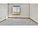 Bright bedroom featuring a large window with views of the outdoors and neutral carpeting at 8050 Bryant St, Westminster, CO 80031