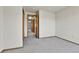 View of neutral carpeted bedroom showcasing multiple access doors and neutral wall color at 8050 Bryant St, Westminster, CO 80031