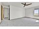 A bedroom with neutral carpet and walls, a ceiling fan, and an ensuite bath at 8050 Bryant St, Westminster, CO 80031