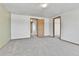 Bedroom featuring neutral carpeting, soft green accent wall, and multiple access doors at 8050 Bryant St, Westminster, CO 80031