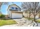 A view of an attractive house with a stone facade and a large two-car garage on a sunny day at 8050 Bryant St, Westminster, CO 80031