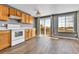 Sunlit kitchen features wood cabinets, and a sliding glass door leading to the backyard at 8050 Bryant St, Westminster, CO 80031
